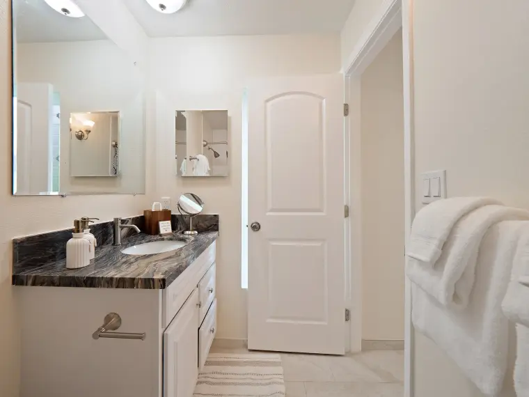 Bathroom vanity with granite counter and mirror