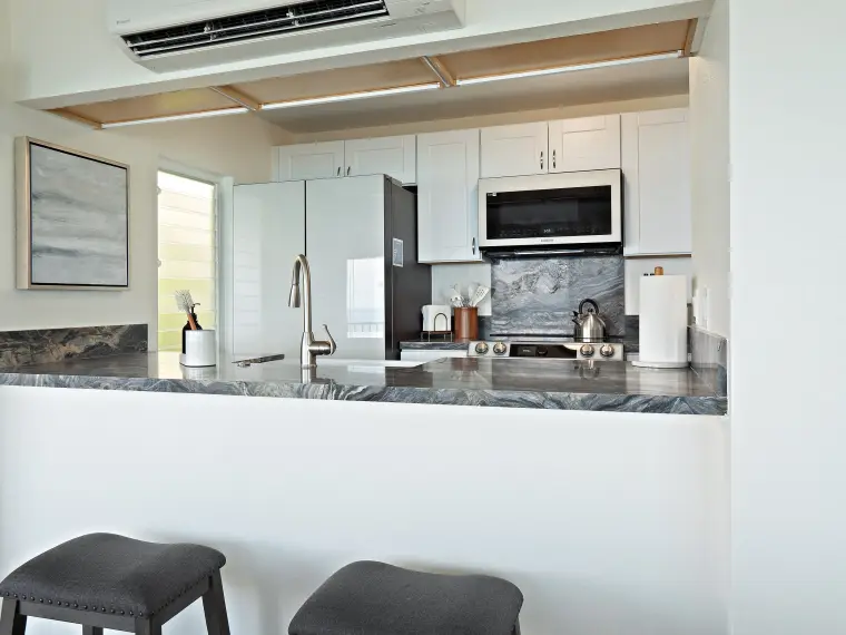 Kitchen bar with stools and granite countertop
